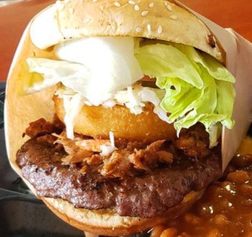 Pulled Pork Burger w/Onion Ring, BBQ Sauce Spicy & Coleslaw*** from All American BBQ in West Hills, CA