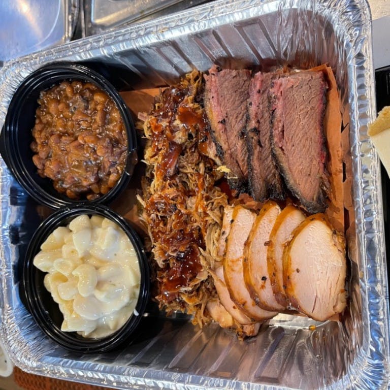 Dinner for 2: 1 lb. 1/3 lb. each of Brisket, Pork & Chicken. Sides: 1/2 lb. @ Smoked Apple Pie Baked Beans and White Cheddar Mac N Cheese. from Beef Butter BBQ - N Sherman Ave in Madison, WI